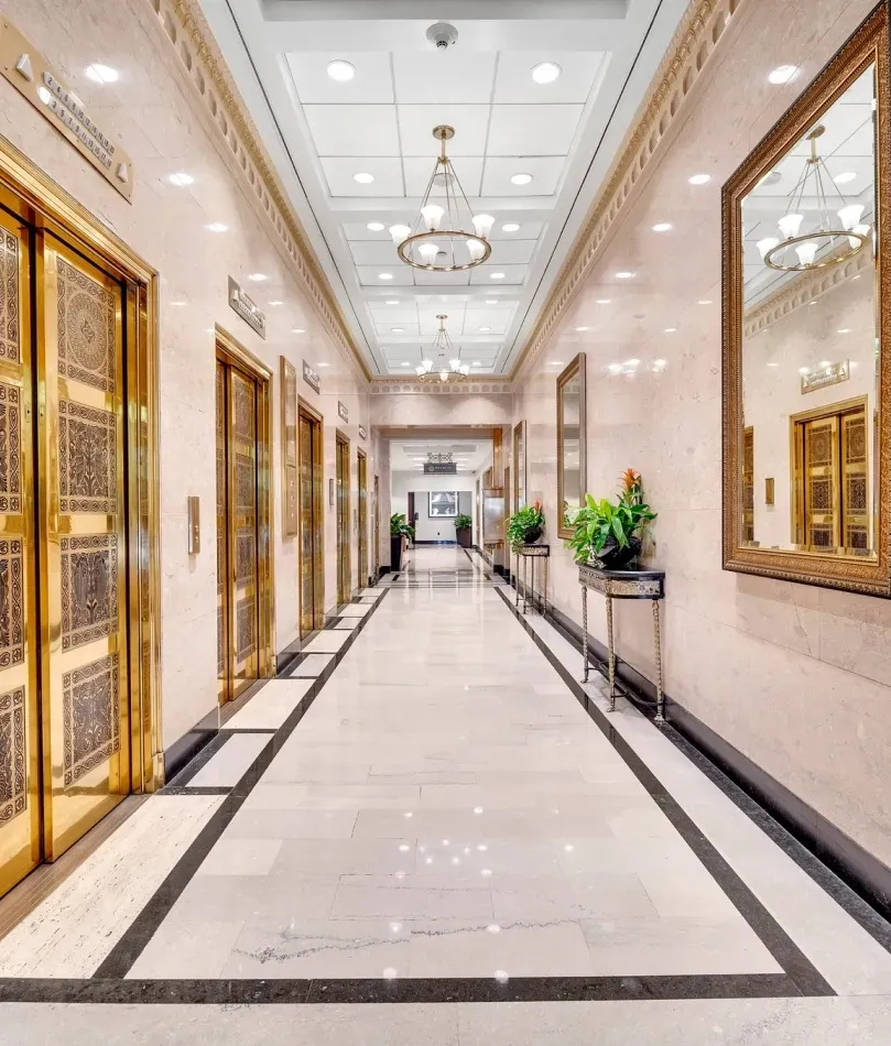 Historic Tryon Plaza hallway with gold elevator doors