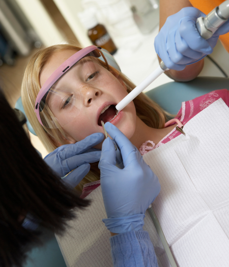 Our dentist examining a young girl near Woodford Green at Dentistry Of Uptown Charlotte