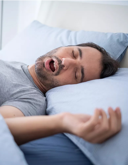 A Man in Charlotte NC sleeping with mouth open, showing signs of sleep apnea